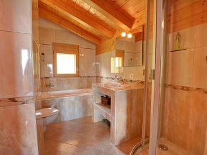 a bathroom with a toilet and a sink and a shower at Chalet Campanule by Interhome in Anzère