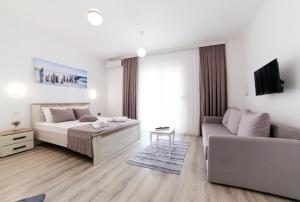 a living room with a bed and a couch at Apartments Hoxha in Ulcinj