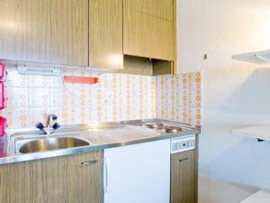 a kitchen with a sink and a counter top at Studio Résidence Velan-2 by Interhome in Les Collons