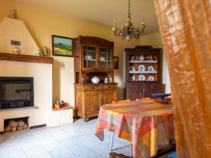 a living room with a table and a fireplace at Holiday Home Casa della Peschiera by Interhome in Isola d'Asti +19 photos