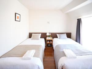 Vuode tai vuoteita majoituspaikassa Pod Select Hotel Shinjuku
