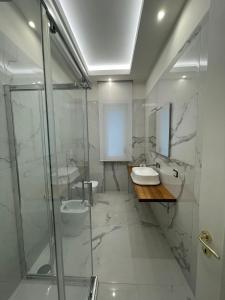 a bathroom with two sinks and a shower at Minori Palace De Luxe Apartment in Minori