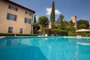 a large swimming pool in front of a building at Residence Villa Antica Torre in San Felice del Benaco
