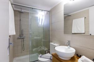 a bathroom with a shower and a sink and a toilet at Adele Riva in Adelianos Kampos