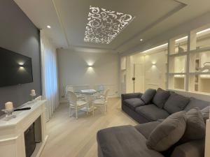a living room with a couch and a table at Minori Palace De Luxe Apartment in Minori