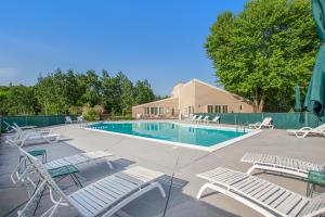 a swimming pool with lounge chairs and a swimming pool at Mountain Seclusion in Harbor Springs