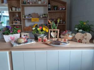 a counter with flowers and other items on it at 4 persoons ingerichte tent op kleine camping in Anna Paulowna