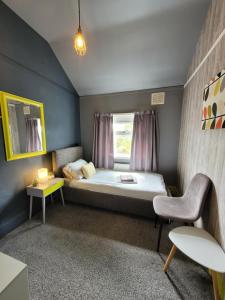 a small room with a bed and a window at Room@87 in Ellesmere Port