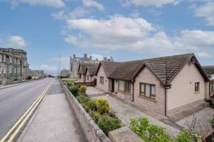 a row of houses on the side of a road at Bowmore in Lossiemouth