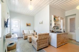 a kitchen and living room with a table and chairs at Castel Abaso Boutique Apartments by Explore Andros in Andros