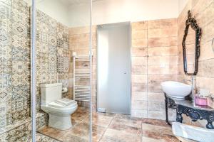 a bathroom with a toilet and a sink at Castel Abaso Boutique Apartments by Explore Andros in Andros