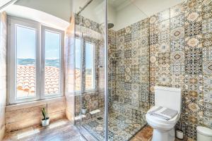 a bathroom with a shower and a toilet at Castel Abaso Boutique Apartments by Explore Andros in Andros
