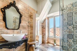 a bathroom with a sink and a mirror at Castel Abaso Boutique Apartments by Explore Andros in Andros