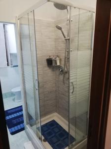 a shower with a glass door in a bathroom at B&B Casa William in Castellammare di Stabia