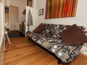 a couch in a living room with a wooden floor at Apartment Ardève 13 by Interhome in Ovronnaz +10 photos