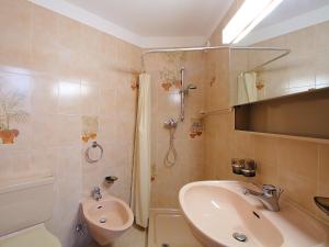 a bathroom with a sink and a shower and a toilet at Apartment Residenza Chesa Margun 14-1 by Interhome in Surlej +14 photos