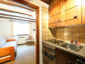 a kitchen with a sink and a bed in a room at Apartment Residenza Chesa Margun 14-1 by Interhome in Surlej