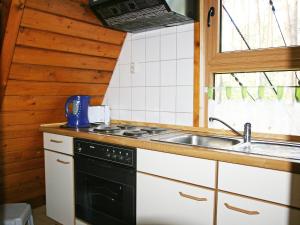 a kitchen with a stove and a sink at Chalet Nepumuk-2 by Interhome in Arendsee