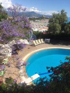 una piscina con sillas y vistas a la ciudad en Grand Hotel De Rose, en Scalea