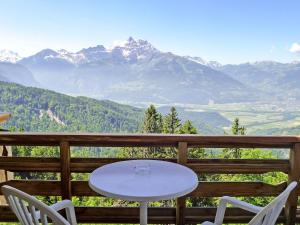 una mesa y sillas en un balcón con montañas en Apartment Le Bristol B52 by Interhome en Villars-sur-Ollon