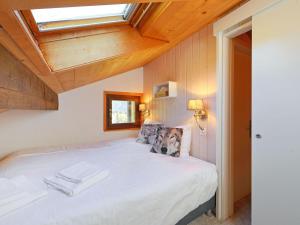 a bedroom with a dog sitting on a bed at Apartment Les Petites Maraîches 132-389 by Interhome in Taveyannaz +13 photos