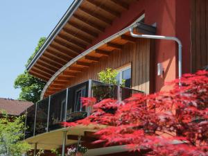 a building with a balcony with red leaves on it at Apartment Dahoam-2 by Interhome in Forstau