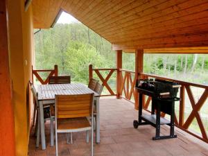 a screened in porch with a table and a piano at Holiday Home Borowikowa by Interhome in Sasino