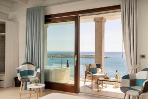 a living room with a view of the ocean at Hotel Ristorante La Conchiglia in Cala Gonone
