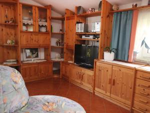 a living room with wooden cabinets and a television at Apartment Eisele by Interhome in Kirchberg bei Mattighofen