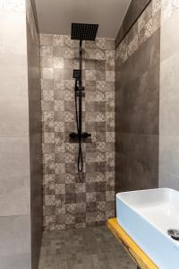 a bathroom with a shower with a tub and a sink at Black Deer in Czarna Góra