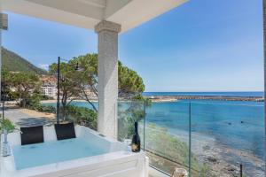 a bath tub with a view of the ocean at Hotel Ristorante La Conchiglia in Cala Gonone