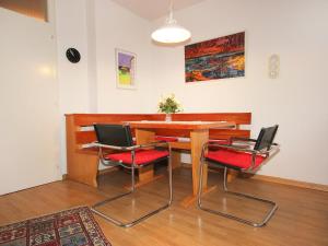 a dining room with a table and four chairs at Apartment Am Birkenhain-19 by Interhome in Seefeld in Tirol