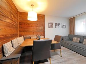 a dining room with a table and a couch at Apartment Grillon-3 by Interhome in Zermatt