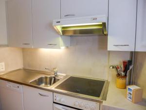 a kitchen with a sink and a microwave at Apartment Villars Soleil B15 by Interhome in Villars-sur-Ollon