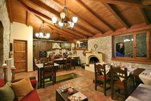 a large kitchen and living room with a fireplace at Archontiko Kolokotroni in Stemnitsa