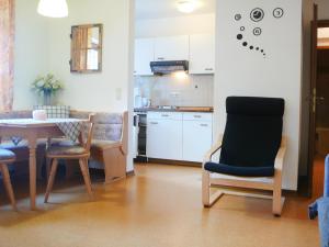 a kitchen and dining room with a table and chairs at Apartment Buchenhöhe-2 by Interhome in Resten