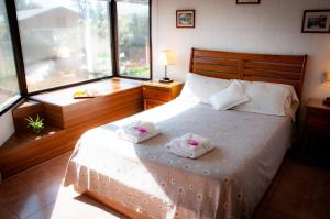 1 dormitorio con 1 cama con 2 toallas en Bad-wiessee Apart Hotel & Spa en Villa General Belgrano