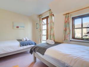 a bedroom with two beds and a window at Holiday Home June Cottage by Interhome in Padstow
