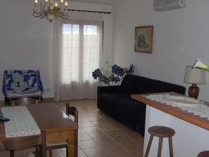 a living room with a couch and a table at Appartamenti Il Girasole in Greve in Chianti