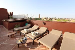 a patio area with chairs, tables, chairs and umbrellas at Riad Sidi Mimoune & Spa in Marrakesh