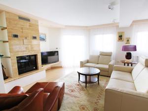 a living room with a couch and a table at Holiday Home Villa Mustra by Interhome in Okrug Donji