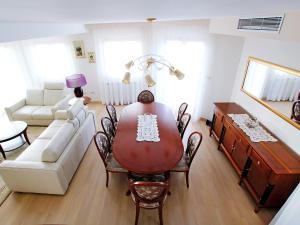 a living room with a dining room table and a couch at Holiday Home Villa Mustra by Interhome in Okrug Donji +17 photos