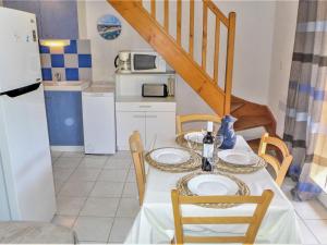a kitchen with a table and chairs and a kitchen with a table and a table at Holiday Home Plein Sud by Interhome in Narbonne-Plage