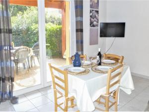 a dining room with a table and a television at Holiday Home Plein Sud by Interhome in Narbonne-Plage