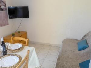 a small living room with a table and a couch at Holiday Home Plein Sud by Interhome in Narbonne-Plage