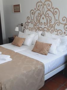 a bedroom with two beds with white sheets and pillows at Casa da Travessa in Ponte de Lima