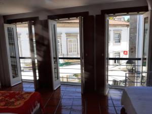 a room with doors open to a balcony at Casa da Travessa in Ponte de Lima