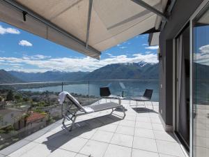 a balcony with a view of a lake and mountains at Hotel Stella SA in Locarno