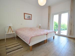 a bedroom with a bed and a table and a window at Apartment Mira-3 by Interhome in Umag +17 photos
