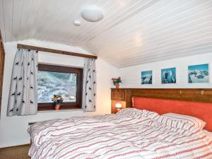 a bedroom with a large bed and a window at Holiday Home Lotte by Interhome in Sirnitz-Sonnseite